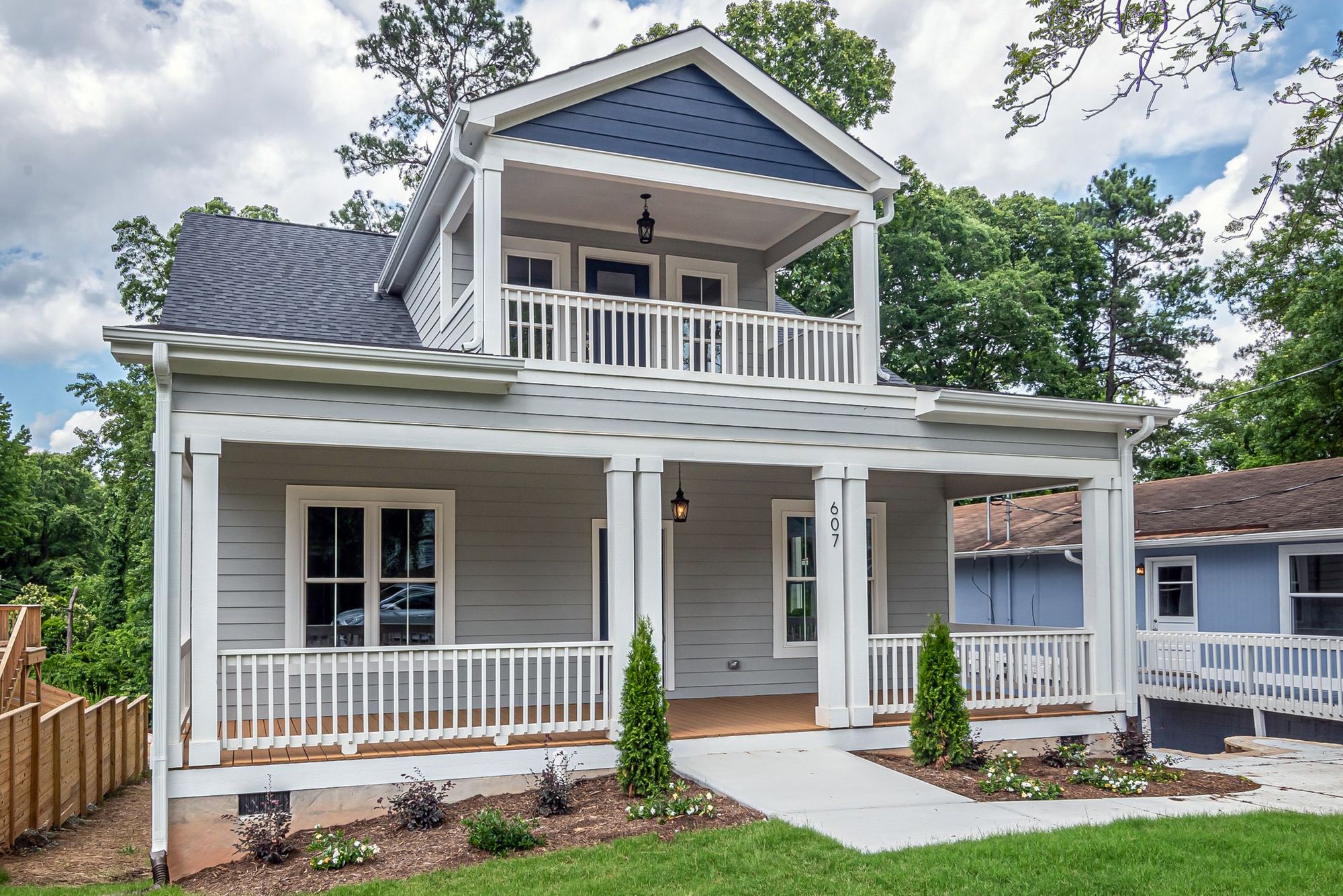 Two-story home with new siding, trim and a full front porch