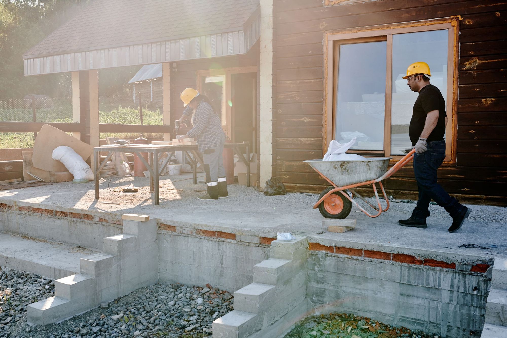 Crew working on a house exterior mid-project