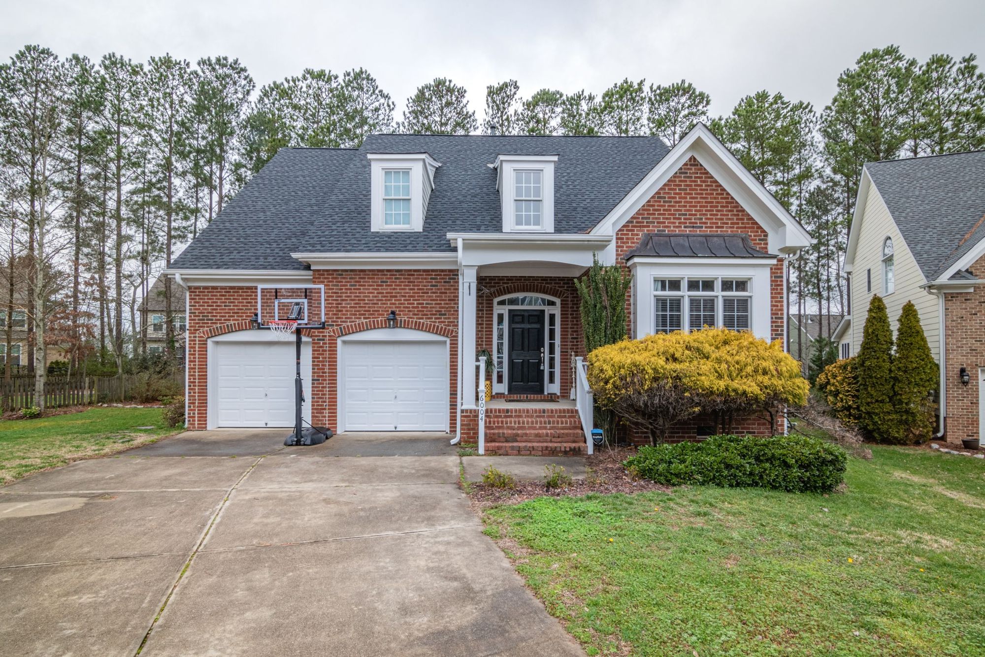 Brick suburban home with a replaced roof and garage