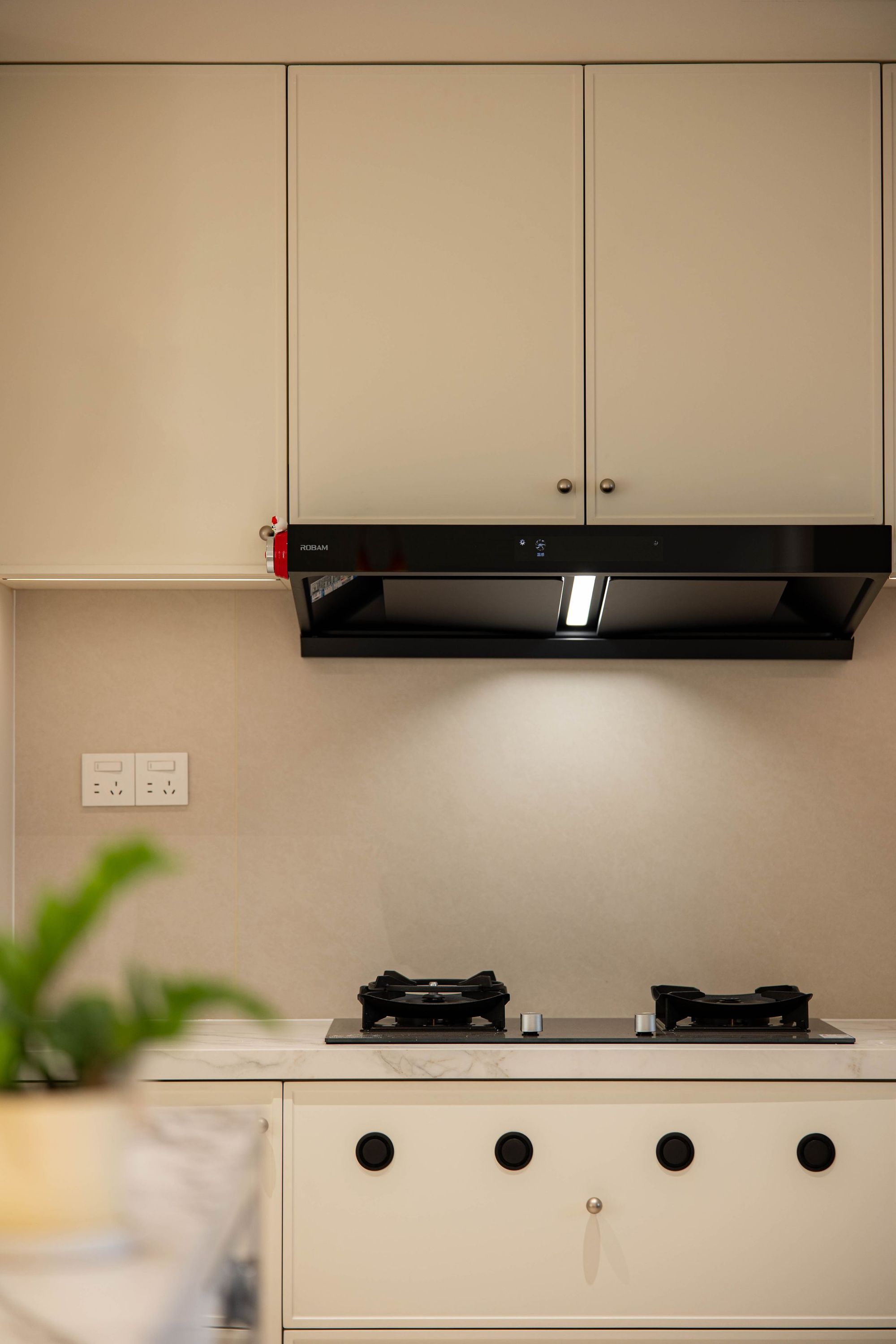 Two-tone kitchen with a dark range hood, Ballantyne
