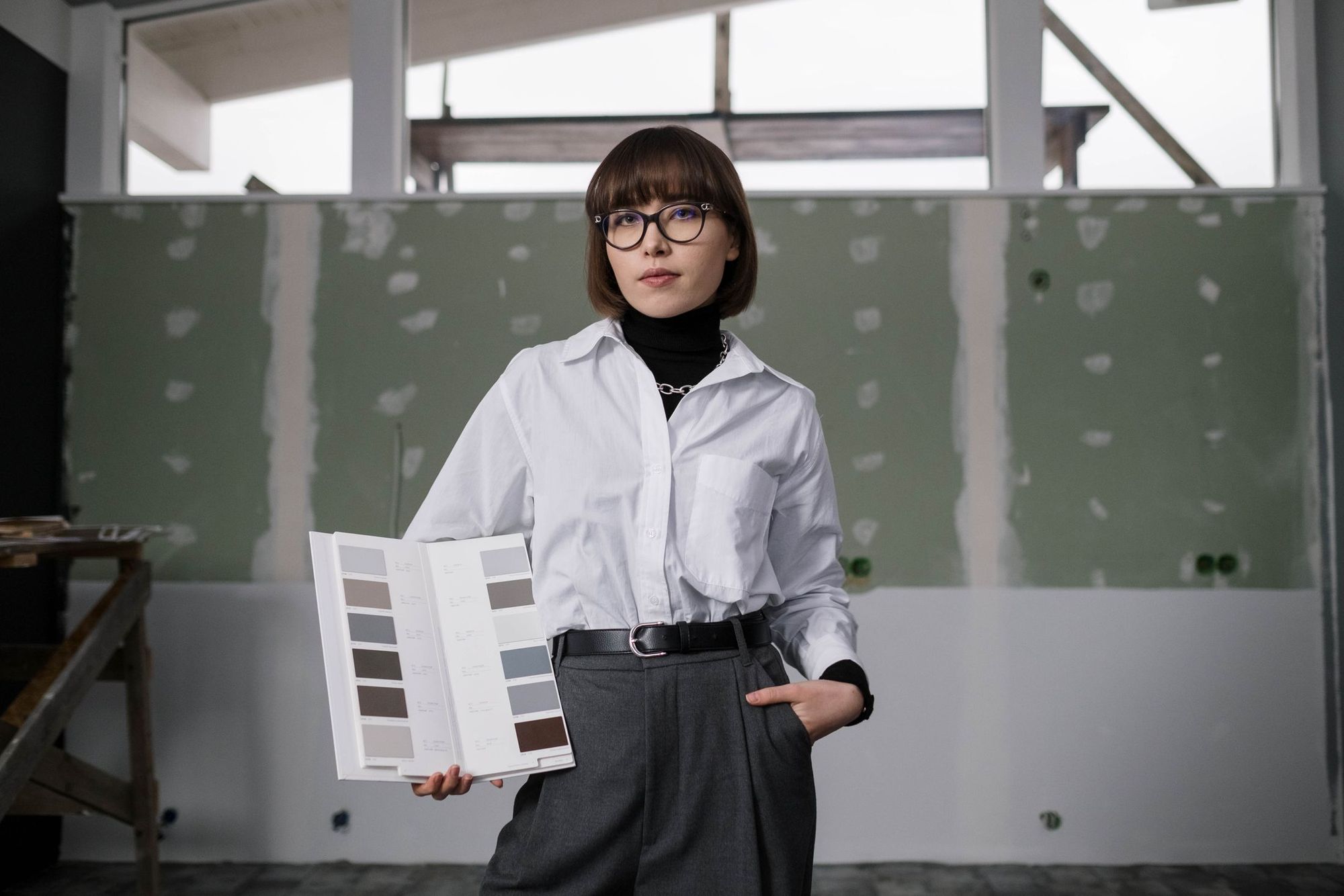 Renee Halvorsen, owner of Dovetail, holding finish samples on a job site