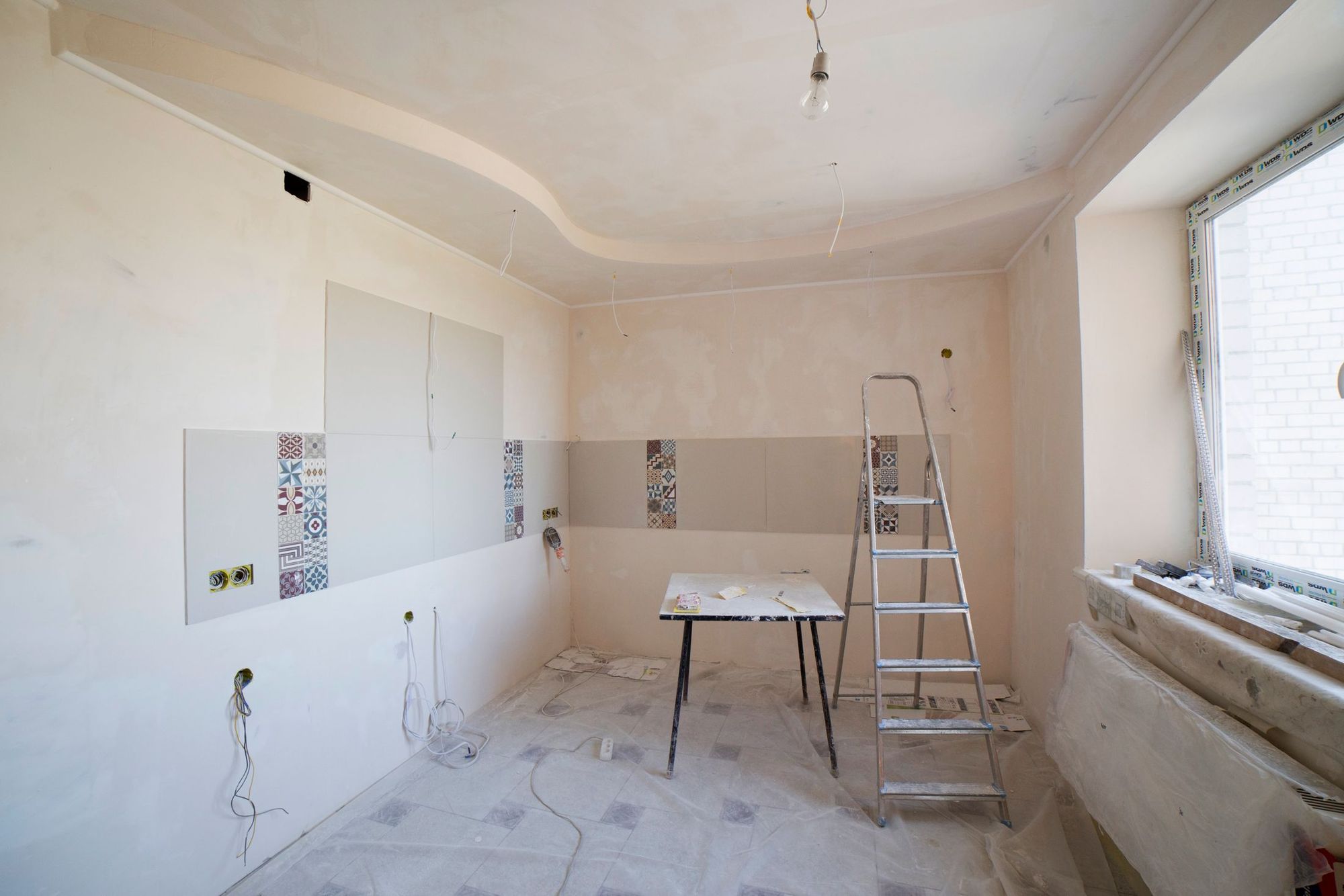 Dust walls and floor protection set up during an active kitchen build