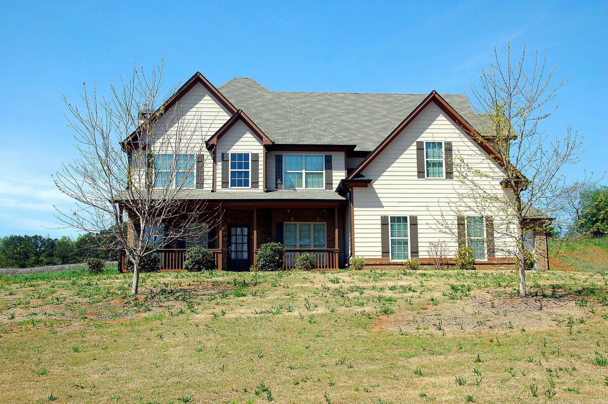 Two-story house with a thin, patchy lawn