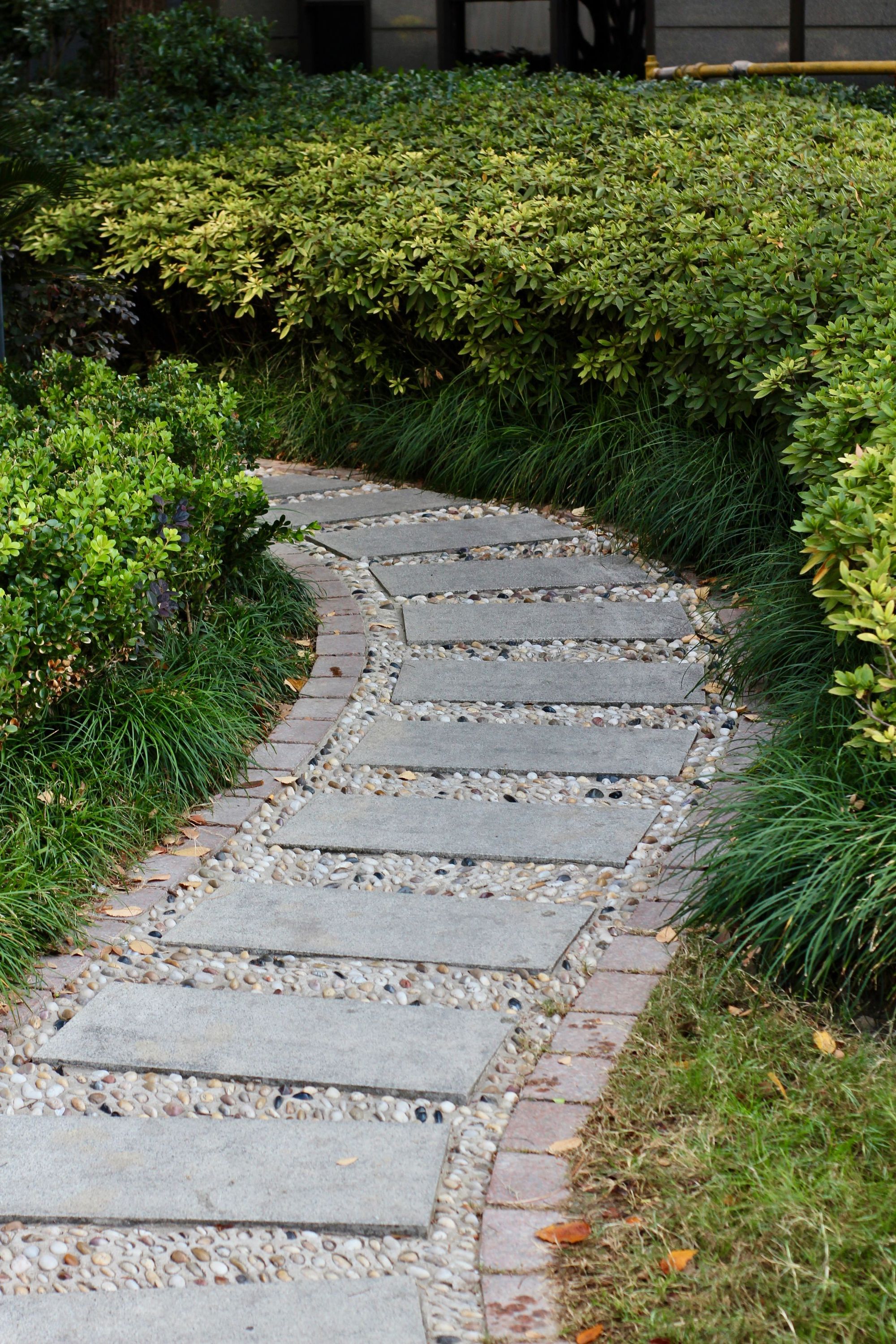 Curved stone stepping path through a planted border