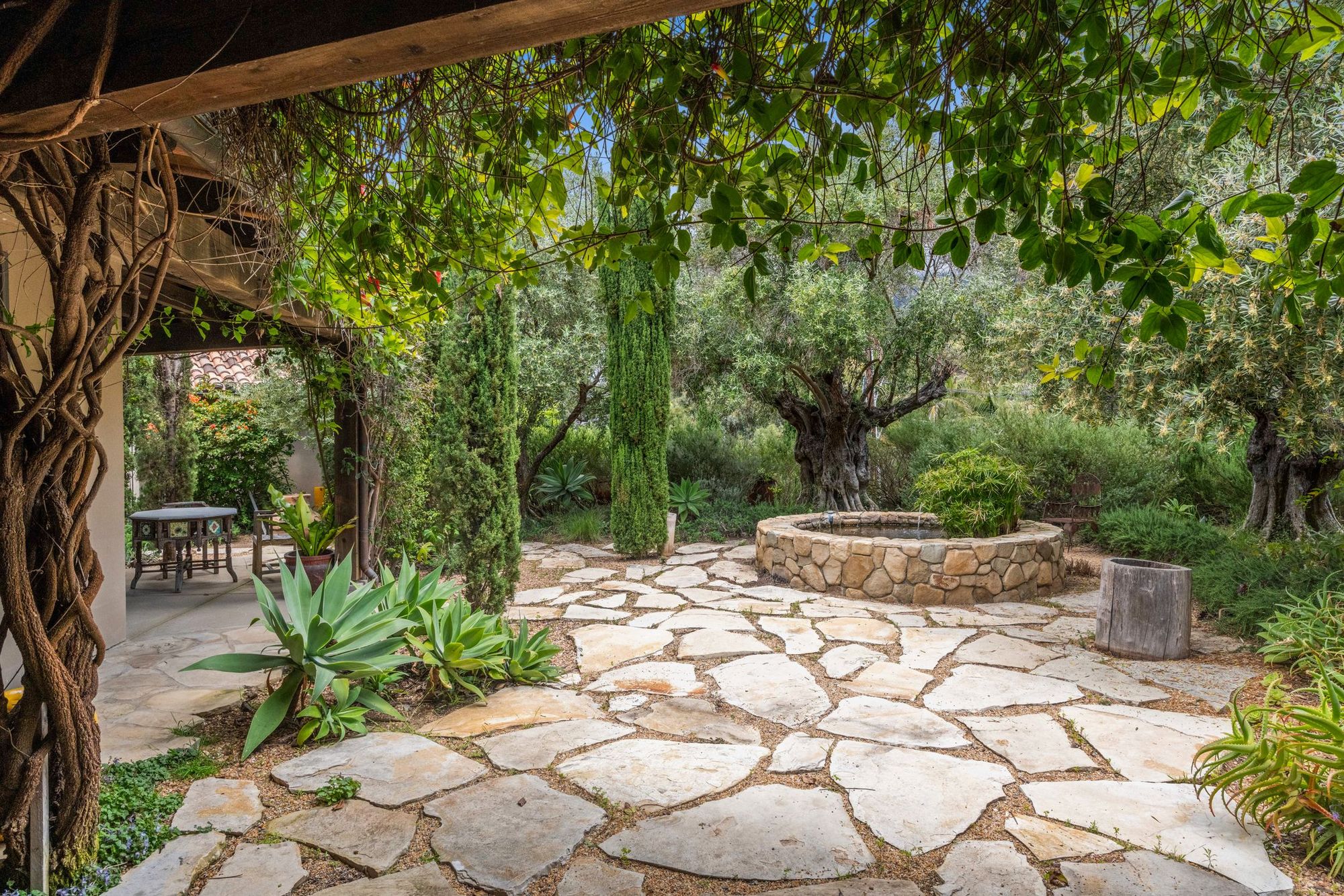 Flagstone terrace under a vine-covered pergola