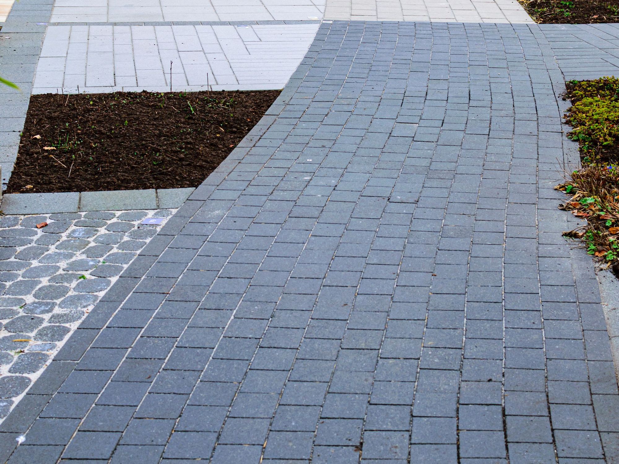 Gray paver walkway between planting beds