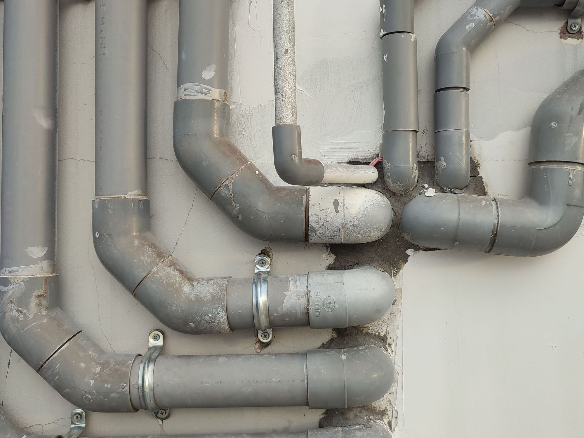 Neatly run supply pipes along a utility room wall