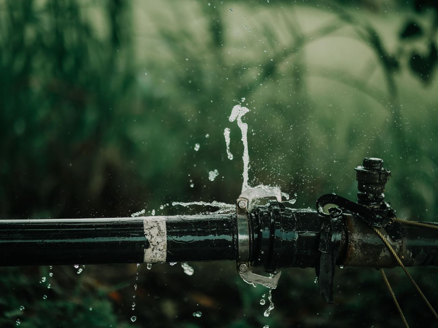 Water spraying from a failed joint on an outdoor supply line