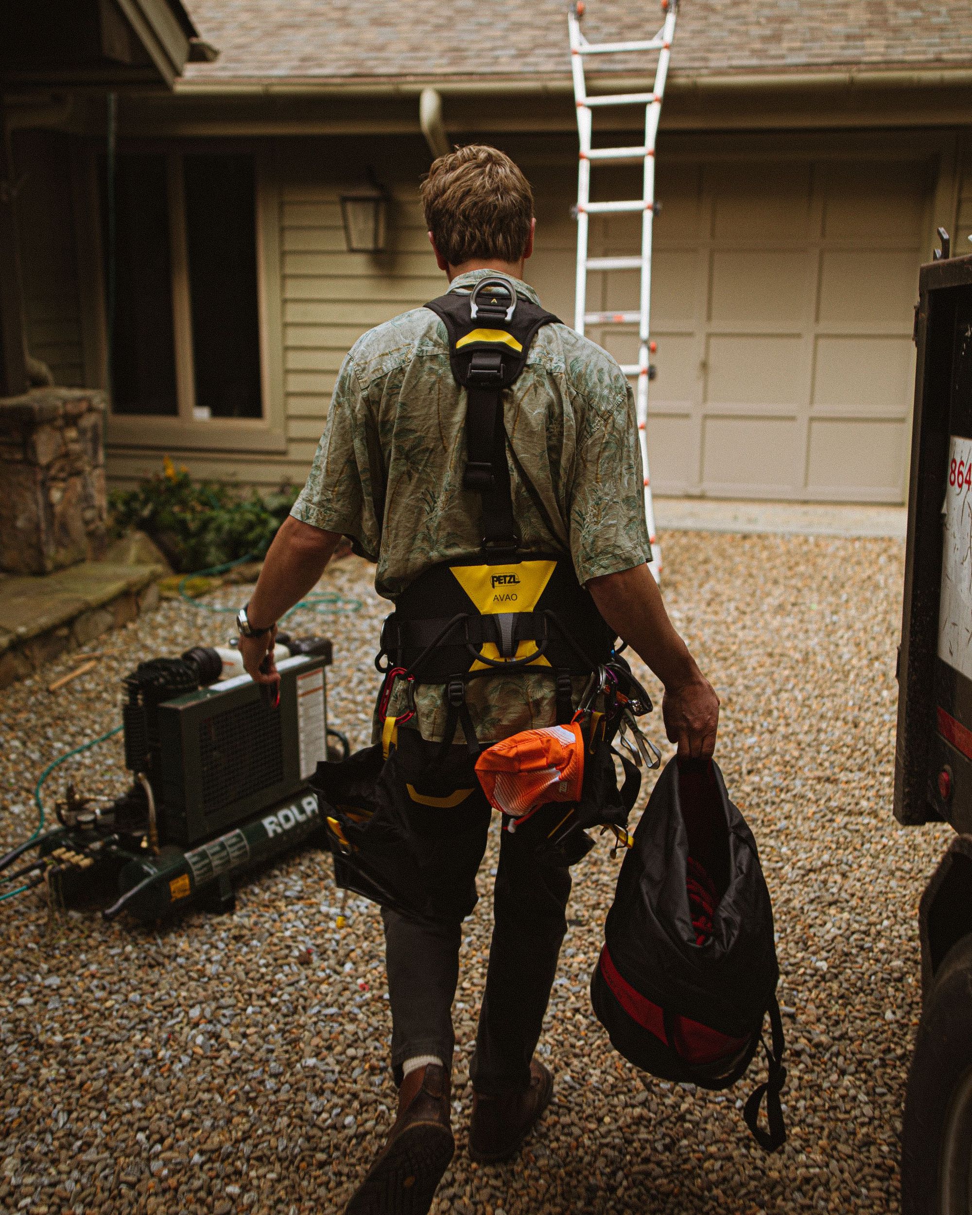 Roofer carrying his gear up the driveway on the first morning