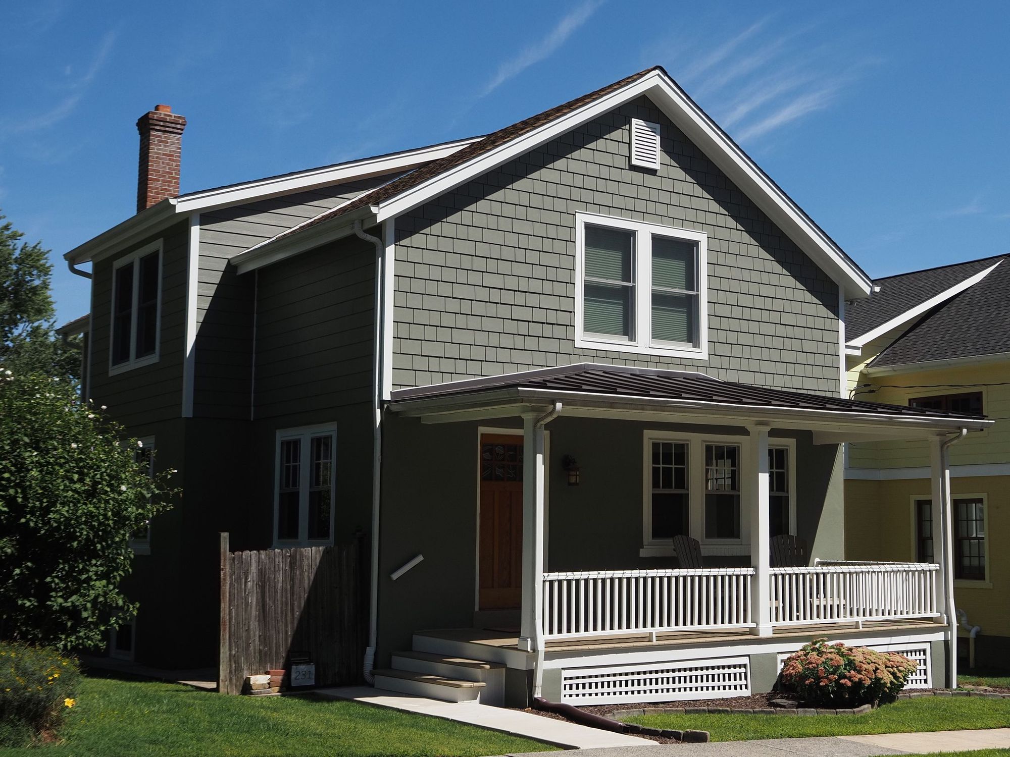 Standing seam metal roof section on a house with a covered porch