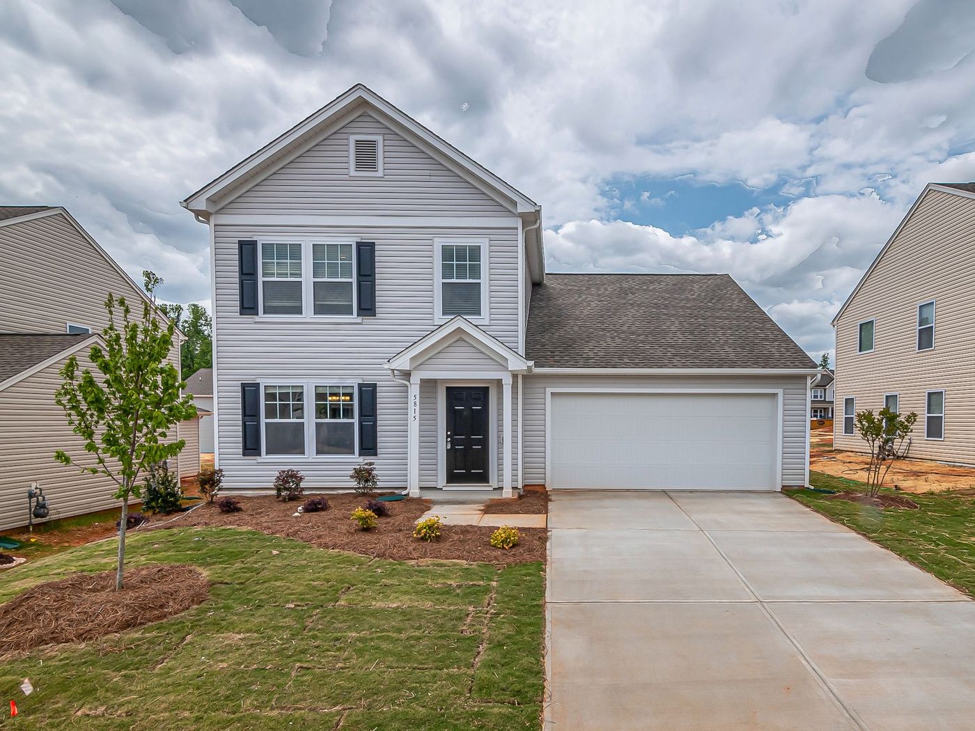 Suburban house with a gabled roof and a paved driveway
