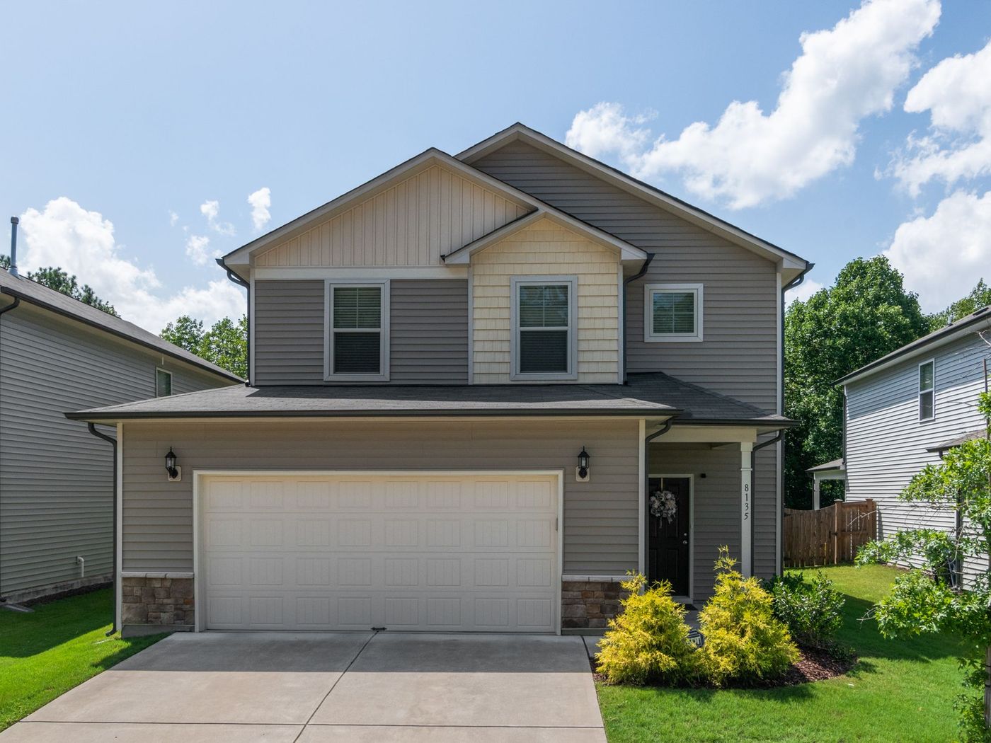 Brick house with an attached garage and a shingle roof