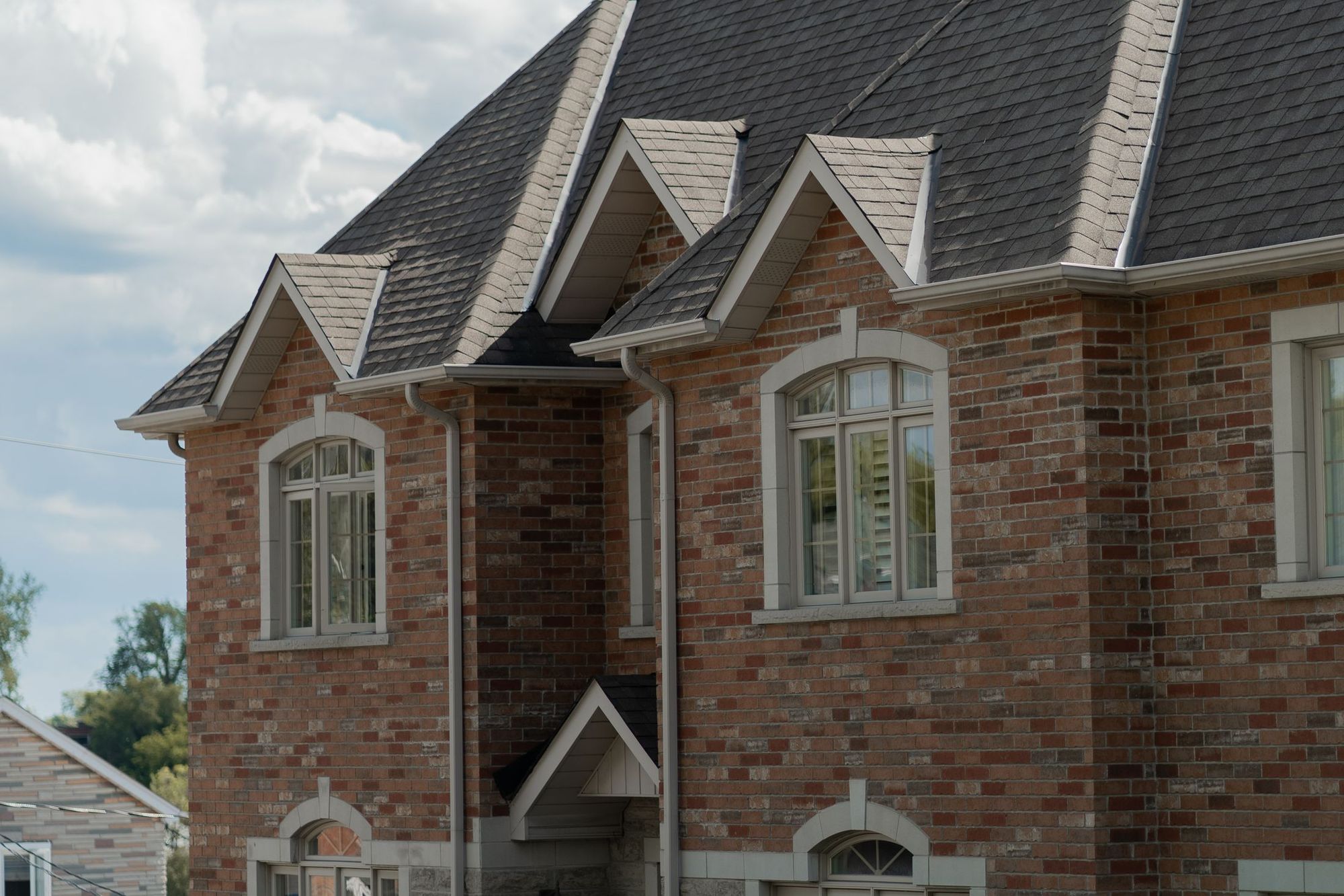 Craftsman style house with dormers and a shingle roof