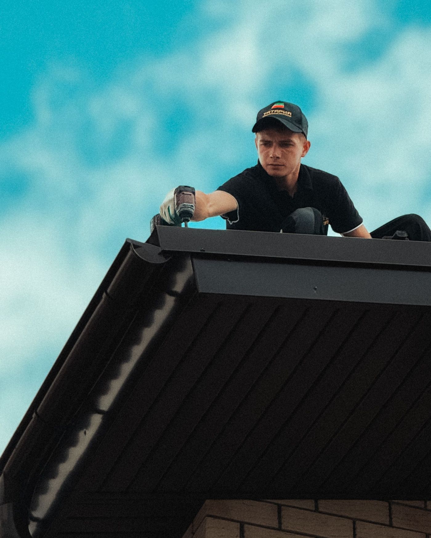 Roofer at the eave checking the edge of the shingles